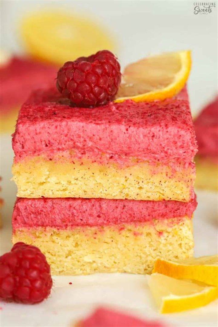 Two raspberry lemon bars stacked on top of each other.